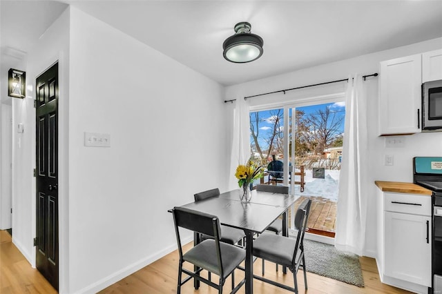 dining area with light hardwood / wood-style floors