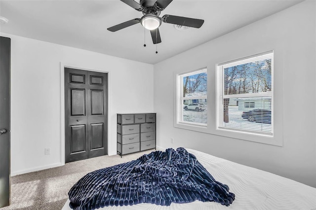 bedroom with carpet flooring, a closet, and ceiling fan