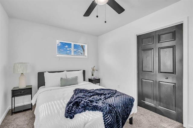 carpeted bedroom featuring a closet and ceiling fan