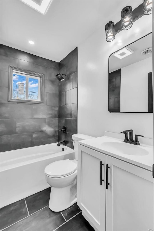 full bathroom with toilet, vanity, tiled shower / bath combo, and tile patterned flooring