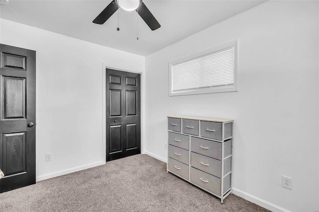 unfurnished bedroom with carpet flooring, a closet, and ceiling fan