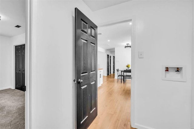 corridor with light hardwood / wood-style flooring