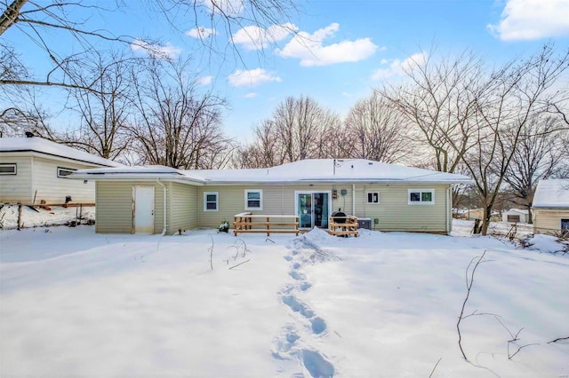 view of snow covered rear of property