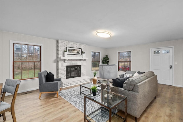 living room featuring a fireplace and light hardwood / wood-style floors