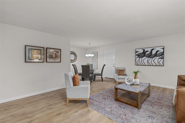 living room with an inviting chandelier and wood-type flooring