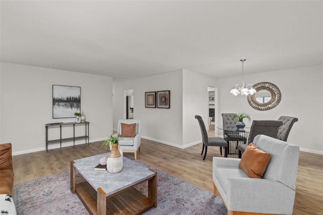 living room with light hardwood / wood-style flooring and a chandelier