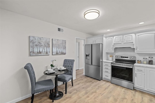 kitchen featuring white cabinetry, light wood-type flooring, and appliances with stainless steel finishes