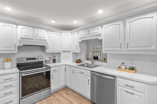 kitchen featuring sink, light hardwood / wood-style floors, white cabinets, and appliances with stainless steel finishes