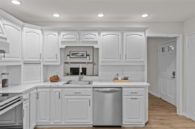 kitchen featuring white cabinetry, appliances with stainless steel finishes, sink, and light hardwood / wood-style flooring