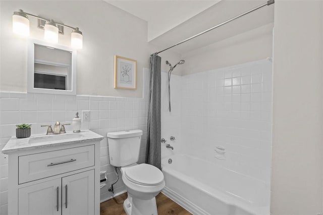 full bathroom with tile walls, hardwood / wood-style flooring, vanity, toilet, and shower / bath combo with shower curtain