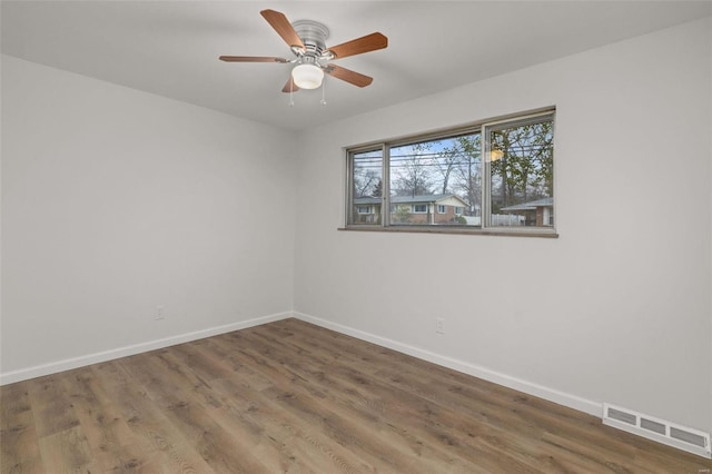 spare room featuring hardwood / wood-style floors and ceiling fan