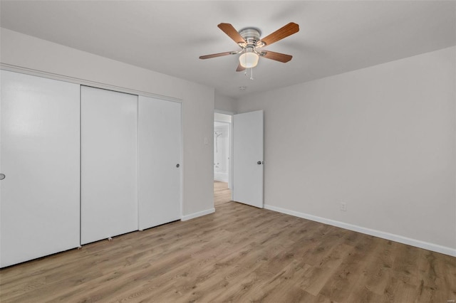 unfurnished bedroom featuring ceiling fan, light hardwood / wood-style floors, and a closet