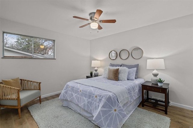 bedroom with ceiling fan and hardwood / wood-style floors