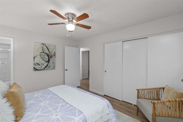 bedroom featuring hardwood / wood-style floors, a closet, and ceiling fan