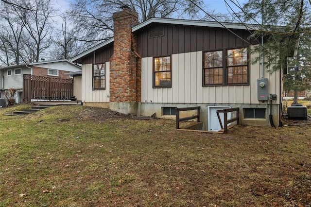 view of property exterior with a yard and central AC unit