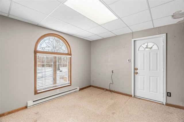 carpeted entryway with baseboards, baseboard heating, and a drop ceiling