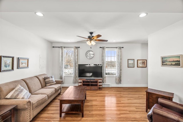 living room featuring light wood-style floors, recessed lighting, and baseboards