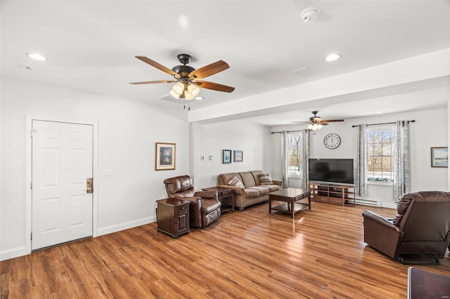 living area with baseboards, a ceiling fan, wood finished floors, and recessed lighting