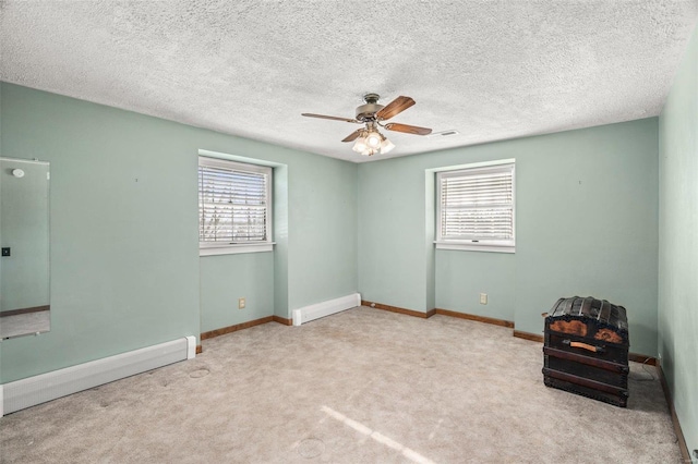 unfurnished room featuring carpet floors, a baseboard radiator, baseboards, and ceiling fan