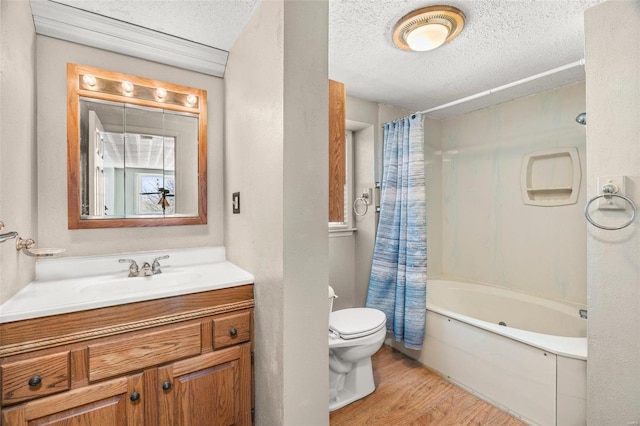 bathroom with a textured ceiling, toilet, wood finished floors, vanity, and shower / bathtub combination with curtain