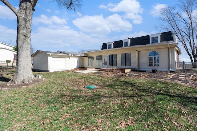 back of property featuring mansard roof, a garage, a shingled roof, fence, and a yard