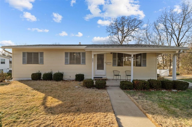 view of front of house featuring covered porch and a front lawn