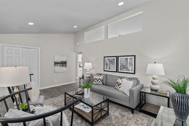 living area with recessed lighting, vaulted ceiling, baseboards, and wood finished floors