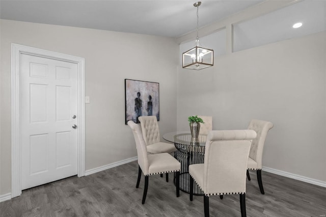 dining room with baseboards, an inviting chandelier, and wood finished floors