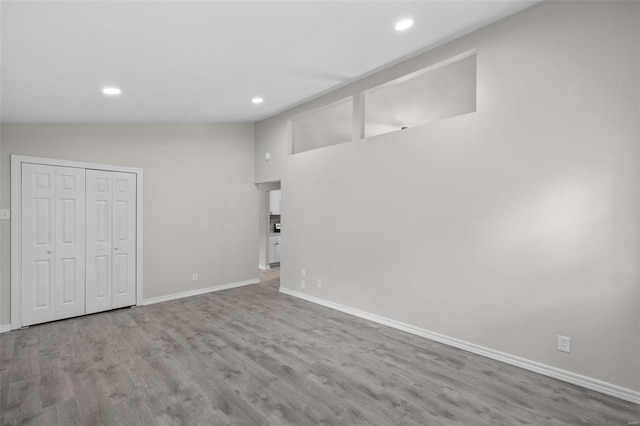 below grade area featuring baseboards, wood finished floors, and recessed lighting