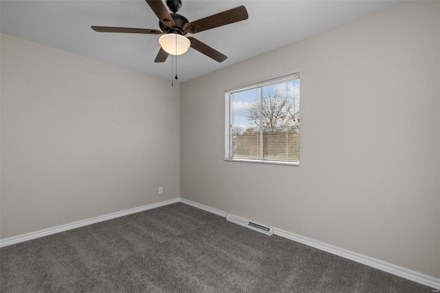 unfurnished room with baseboards, visible vents, dark colored carpet, and a ceiling fan