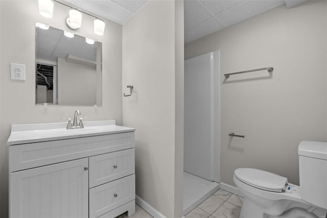 full bathroom with marble finish floor, a paneled ceiling, toilet, and baseboards