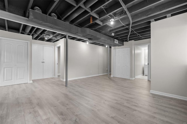 finished basement with baseboards and wood finished floors