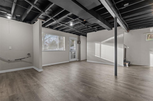 below grade area with baseboards and wood finished floors