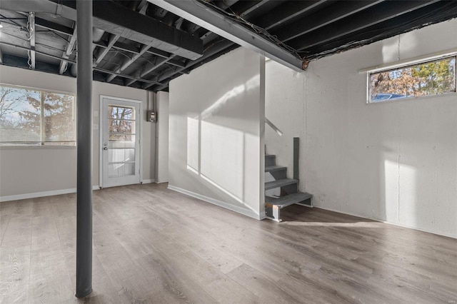 basement with stairs and wood finished floors