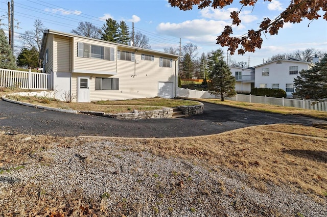 exterior space featuring a garage and fence