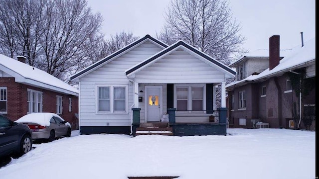 bungalow-style home with central AC unit