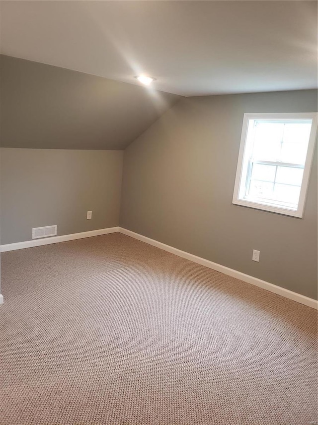 bonus room with carpet floors and lofted ceiling