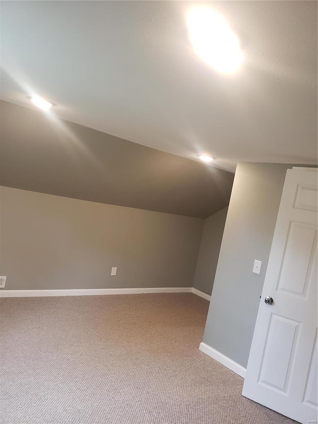 additional living space with carpet and lofted ceiling