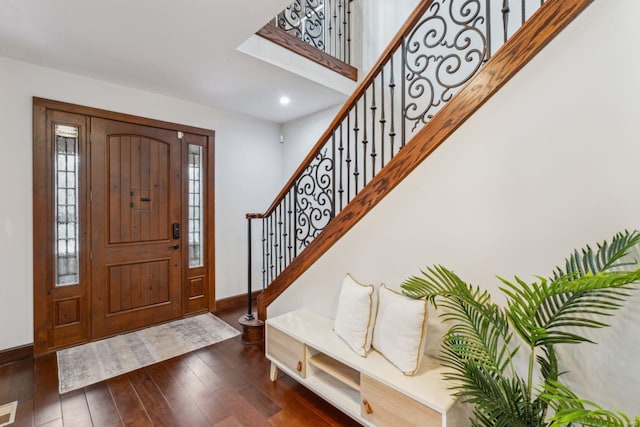 entrance foyer with stairway, baseboards, and dark wood finished floors