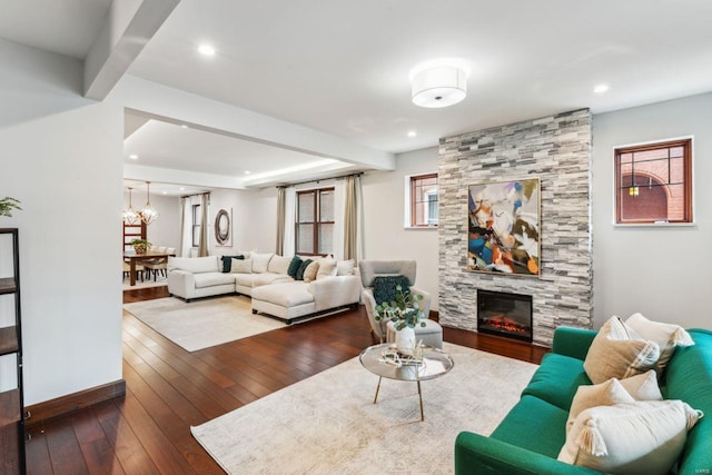 living area with a large fireplace, a chandelier, dark wood-style flooring, and recessed lighting