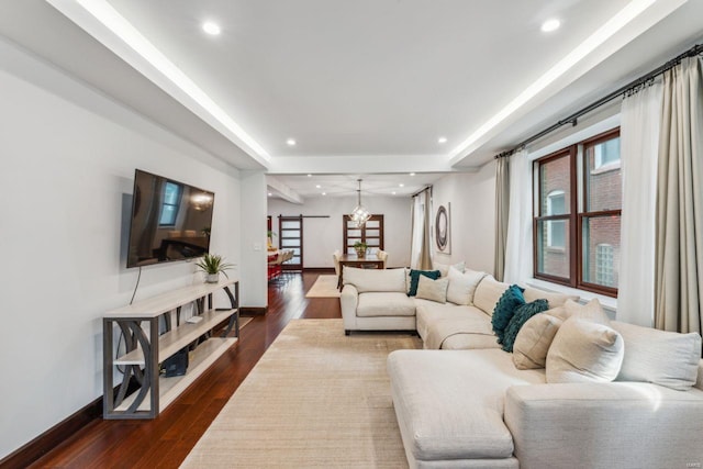 living area with recessed lighting, dark wood-style flooring, and baseboards