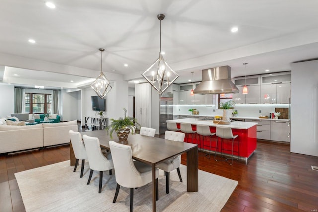 dining room featuring dark wood-style floors, a chandelier, and recessed lighting