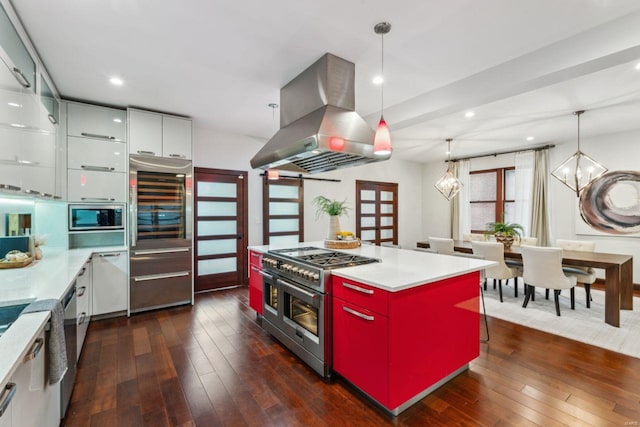 kitchen featuring a center island, island exhaust hood, light countertops, appliances with stainless steel finishes, and modern cabinets