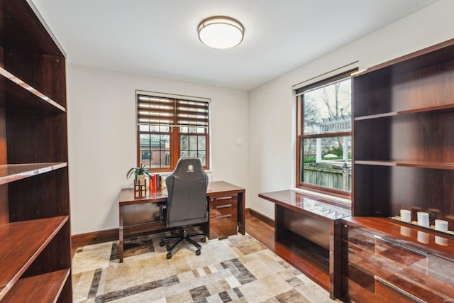 home office featuring light wood finished floors and baseboards