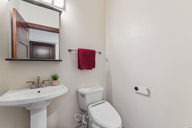 bathroom featuring a sink and toilet