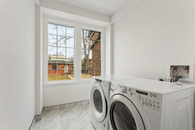 laundry area featuring washer and dryer, laundry area, and marble finish floor