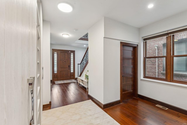 entryway with recessed lighting, visible vents, baseboards, stairs, and dark wood finished floors