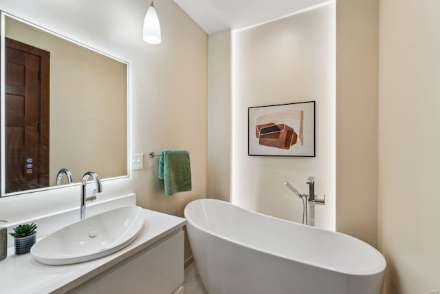 full bathroom with a freestanding bath and vanity