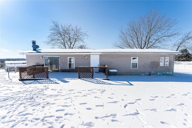 view of snow covered rear of property