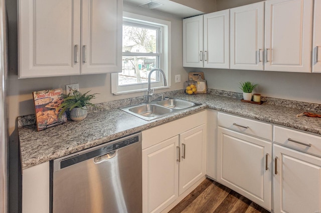 kitchen with dark hardwood / wood-style floors, sink, white cabinets, and dishwasher